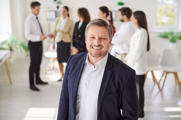 Cheerful portrait of a successful businessman, smiling and happy, working in an office. Highlighting the role of a manager or accountant thriving in a business professional environment.
