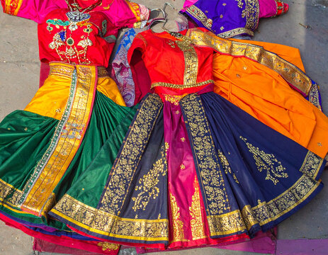Traditional Lavani dance costumes, with their vibrant colors and graceful silhouettes, are laid out, representing the folk dance and cultural expression of Maharashtra.