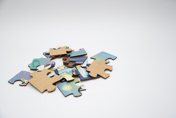 Puzzle pieces in a pile on a white background. Close-up