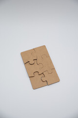 Puzzle pieces in a pile on a white background. Close-up