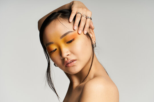 Captivating elegance of a young beautiful asian woman showcasing stunning makeup artistry