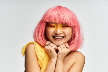 Vibrant moments of joy captured in a youthful Asian woman with a playful pink hairstyle