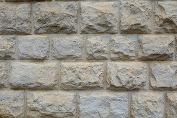 The walls of the building are lined with rough stone as an abstract backdrop. Close-up