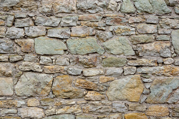 The walls of the building are lined with rough stone as an abstract backdrop. Close-up