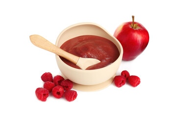 Baby food. Tasty puree in bowl, spoon, apple and raspberries isolated on white