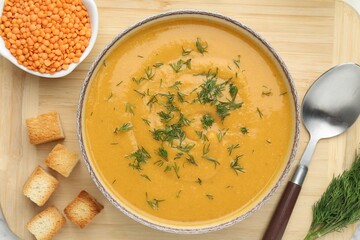 Delicious lentil cream soup with dill on table, top view