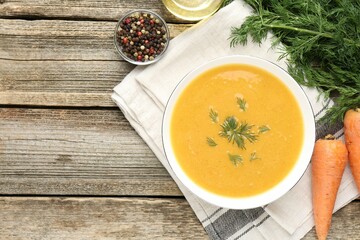 Delicious lentil cream soup with dill served on wooden table, flat lay. Space for text