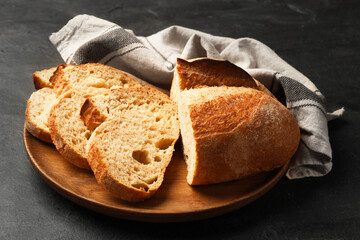 Pieces of fresh bread on black table, closeup