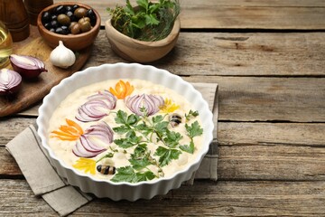 Raw focaccia with vegetables, olives and spices on wooden table, closeup. Space for text