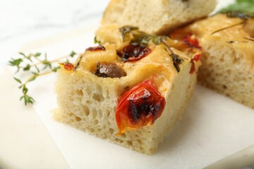Pieces of delicious focaccia on table, closeup