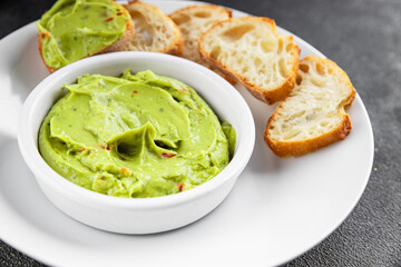 Guacamole dip avocado sauce cold appetizer vegetable pate dish organic product fresh tasty gourmet food background on the table rustic food top view copy space 