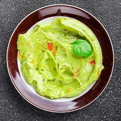 Guacamole dip avocado sauce cold appetizer vegetable pate dish organic product fresh tasty gourmet food background on the table rustic food top view copy space 