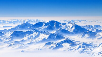 Fototapeta premium Aerial view of majestic snow-capped mountain range piercing through a sea of clouds under a vibrant blue sky