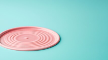 Minimalist Composition: Pastel Pink Round Element with Concentric Waves on a Light Turquoise Surface, a Visual Harmony
