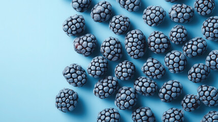 Geometric arrangement of blackberries on a pastel background showcasing clean and modern lighting