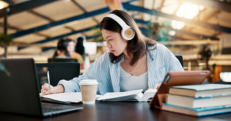 Headphones, writing notes and woman learning in university for knowledge, research or listening to audio. Book, college and serious student study for exam, education or test with technology for music