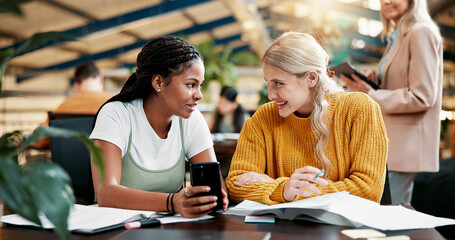Happy, people and friends with phone in library for social media, university gossip and good news. Students, talking and mobile for education schedule, learning website and online rumor for knowledge