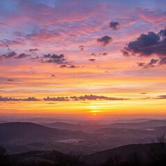 Fototapeta premium Colorful Sunrise Over Mountain Ranges: Witness the breathtaking start of a new day as the sun paints the sky with vivid hues over rolling mountain ranges and a serene landscape.