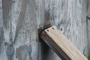 4x4 plank reinforcing a wall or bracing for a storm abstract concept for business, leadership, or extreme weather. design element, banner, or macro close-up background