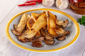 Roasted eringi mushrooms in the plate