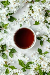 Spring tea in a white mug, surrounded by blossoms
