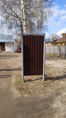 Metal gate in middle of street. Strange door in courtyard