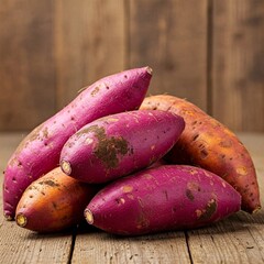 red sweet potatoes on wooden background