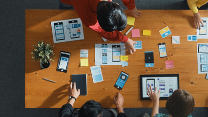 Smart creative team working together while brainstorm about Ux Ui designing mobile phone interface....