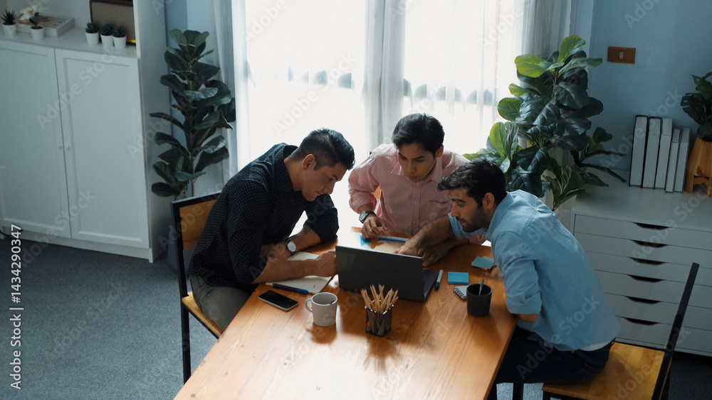 Wall mural top view of smart business team looking at laptop while analyzing marketing data and financial graph