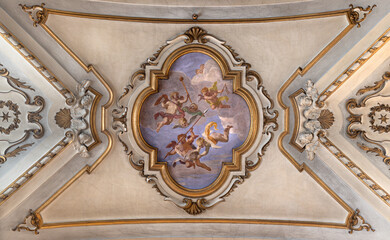 PRATO, ITALY - MARCH 21, 2025: The ceiling fresco of angels with the insturments of crucifixion in...