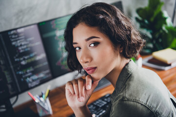 Professional female programmer working at home office with focus on coding tasks and technology...