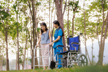 Fototapeta premium With gentle attention and encouragement, a dedicated female physical therapist assists her patient in practicing rehabilitation exercises in the hospital's outdoor garden.