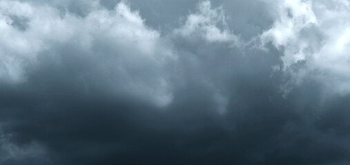 Dark storm sky with dramatic fluffy clouds. Cloudscape rainy season. Thunderstorm climate weather. Pollution smoke PM 2.5 Cabo dioxide concept. Scary Halloween.