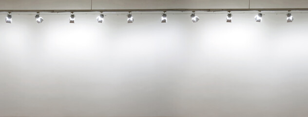 Empty white wall with spot lights at art gallery