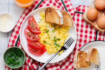 Scrambled eggs, tomatoes and toast for breakfast