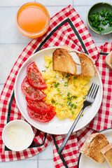 Scrambled eggs, tomatoes and toast for breakfast