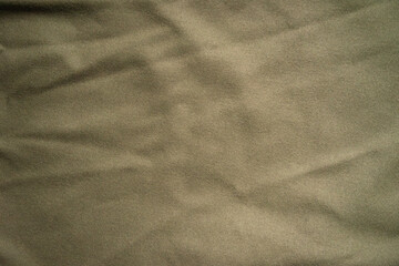 Knitted khaki fabric with a soft texture.Military background for the text.