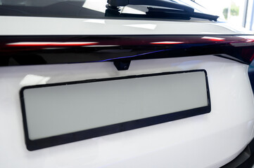 Close-up view of a car's license plate holder with a white background.