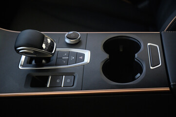 Automatic transmission selector in the interior of a modern car.