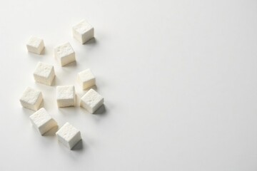 White sugar cubes arranged on white background, clean, still life, food