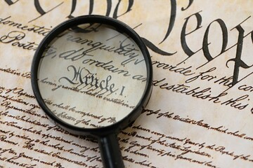 American USA Constitution paper page and magnifying glass close up