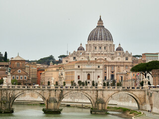 Photo of Vatican City, with the central dome, plaza, monuments, and sculptures. It is a city-state located within Rome, Italy, and the headquarters of the Roman Catholic Church. 
