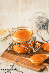 Homemade mango jam on white wooden table