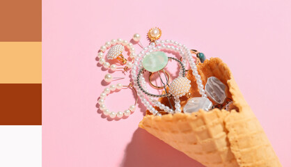 Waffle cone with jewelry on pink background, closeup