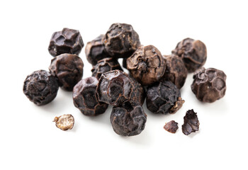 Black peppers isolated on white background. Pile of black peppercorns macro.