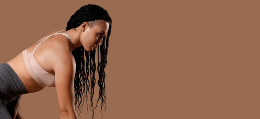 Female bodybuilder on brown background