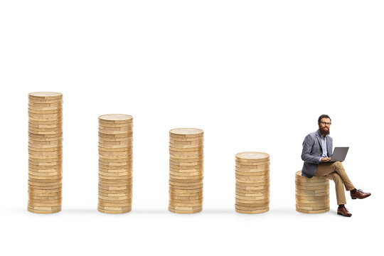 Man with a laptop computer sitting on a pile of coins