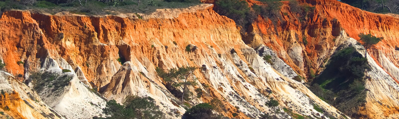 Algarve beach at Olhos de Agua with red cliffs at the coast of south Portugal
