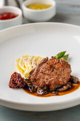 Grilled beef tenderloin with mashed potatoes, vegetables, and sauce