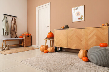 Interior of hallway with autumn decor, door and commode